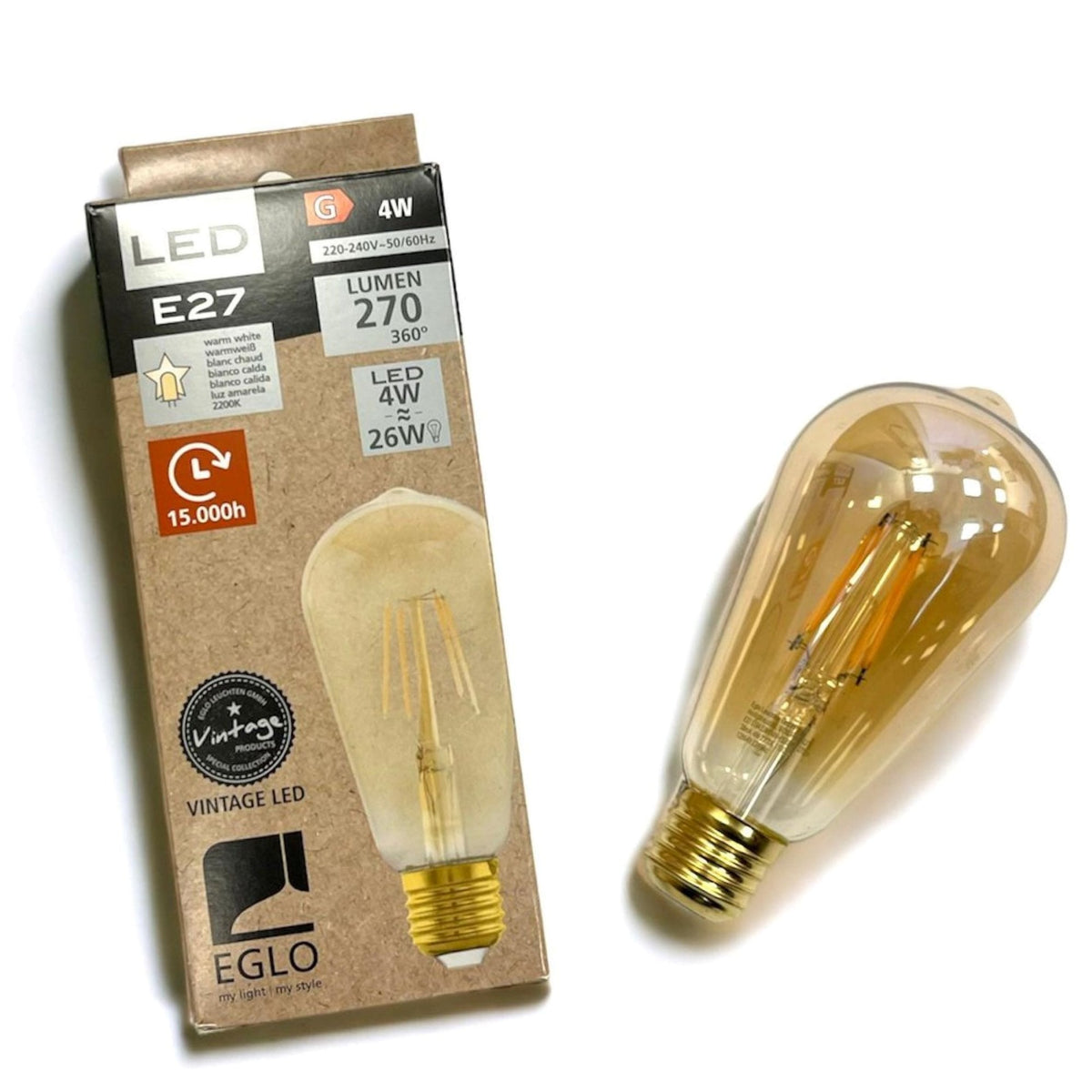 A close up of an EGLO vintage LED bulb next to its cardboard packaging.