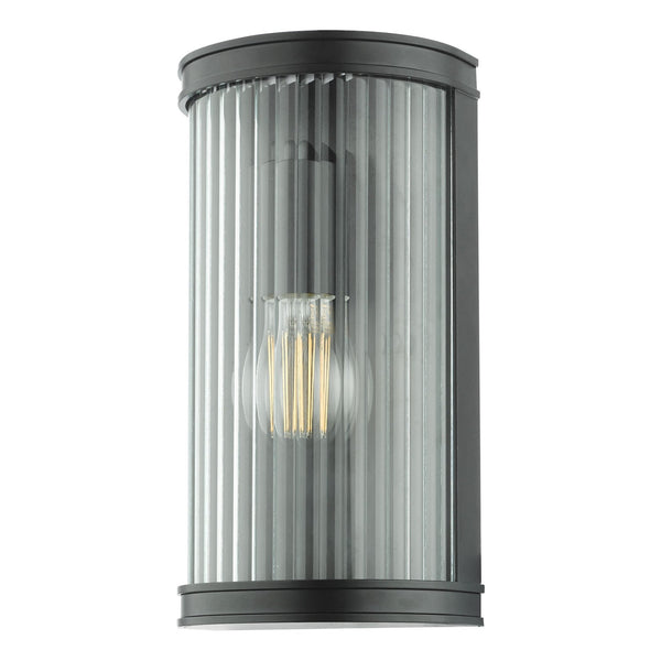 Black outdoor wall light with clear fluted glass and an exposed Edison bulb.