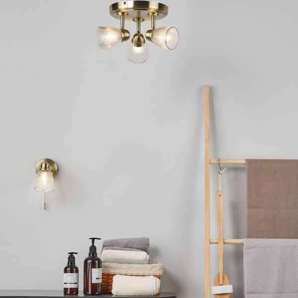 Cedric IP44 Switched Wall Light In Antique Brass With Ribbed Glass Shade