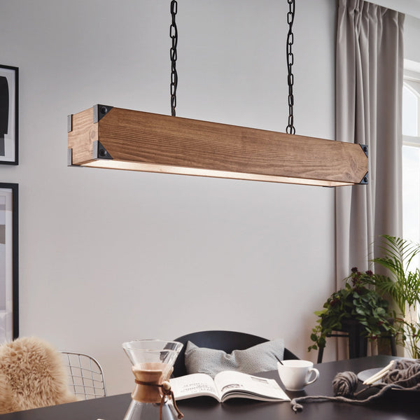Wooden linear pendant light hanging above a table 