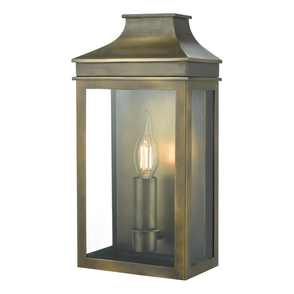 A brass outdoor wall lantern with a single flame-shaped bulb inside.