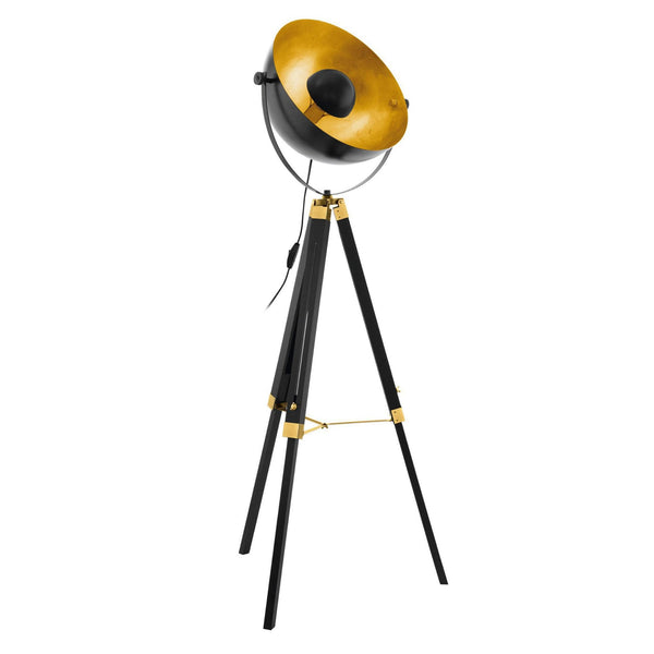 A black and gold industrial tripod floor lamp against a white background.