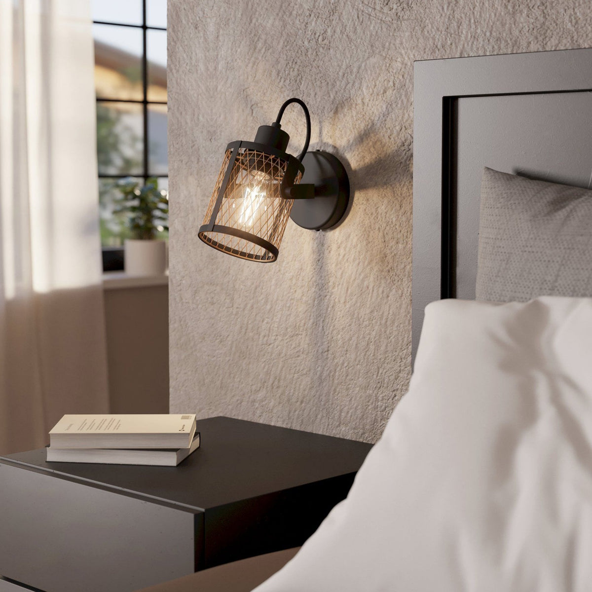 An industrial-style wall light with a ribbed glass shade illuminates a bedroom.