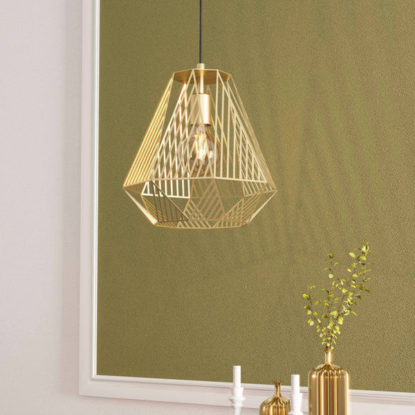 A modern gold geometric pendant light illuminating a room with a green wall and a white frame.