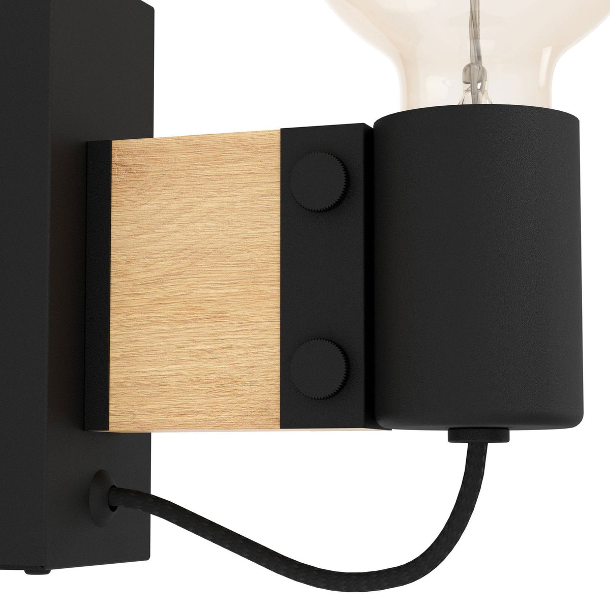 A close-up of the black and gold wall light, showcasing its material and design details.