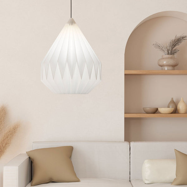 A white pleated pendant light hangs in a minimal living room.