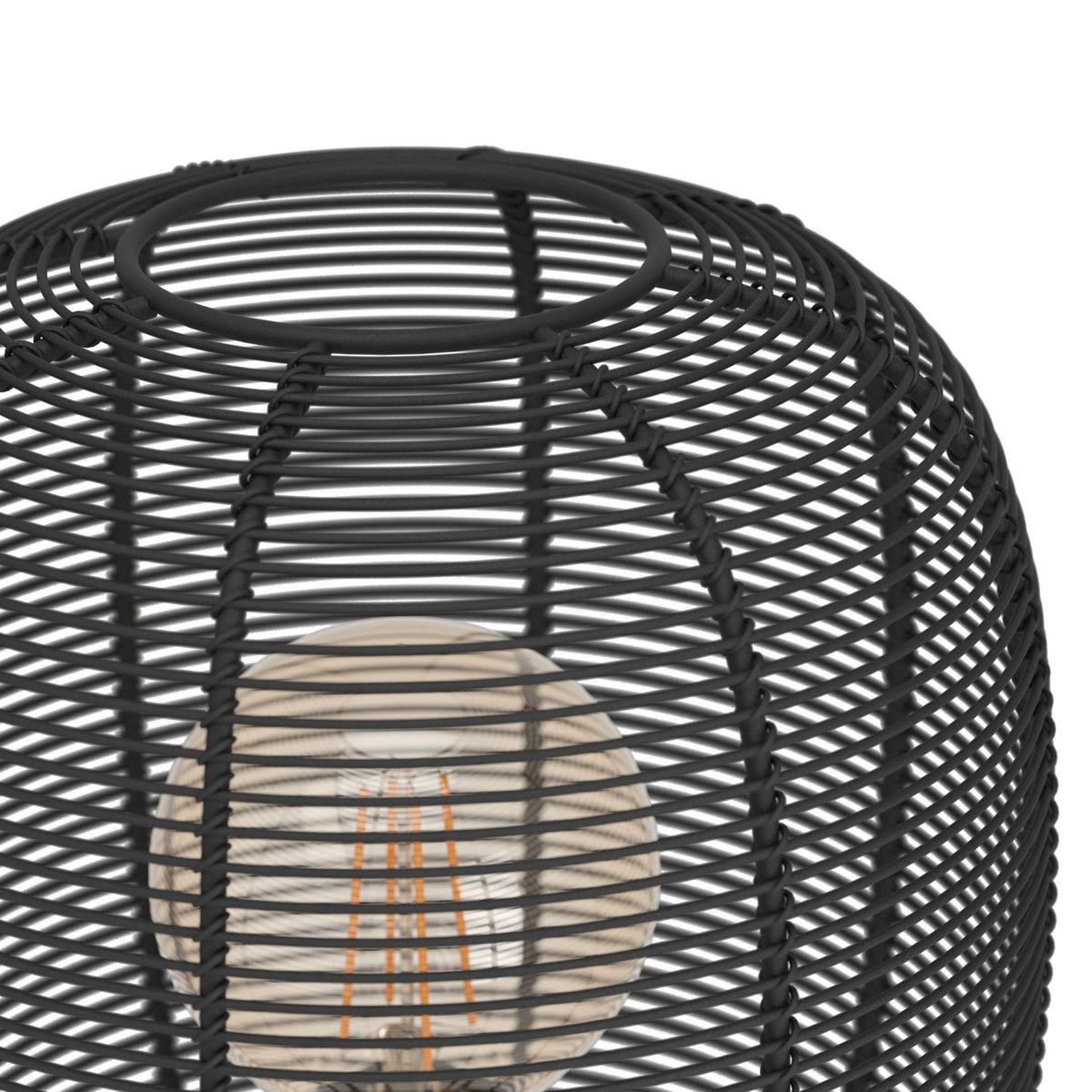 Close-up of the black metal wire cage shade of the table lamp, showing the bulb inside.