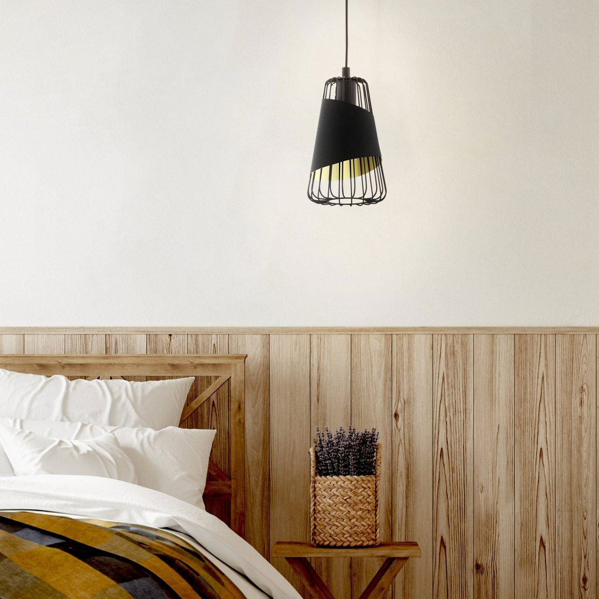 A black and gold pendant light illuminates a rustic bedroom setting.