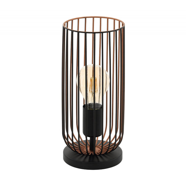 A minimalist black and copper caged table lamp with an exposed filament bulb.