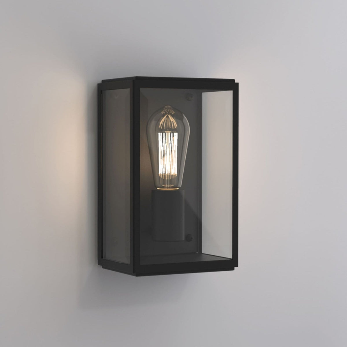 Black rectangular outdoor wall light with clear glass panels and an exposed filament bulb.
