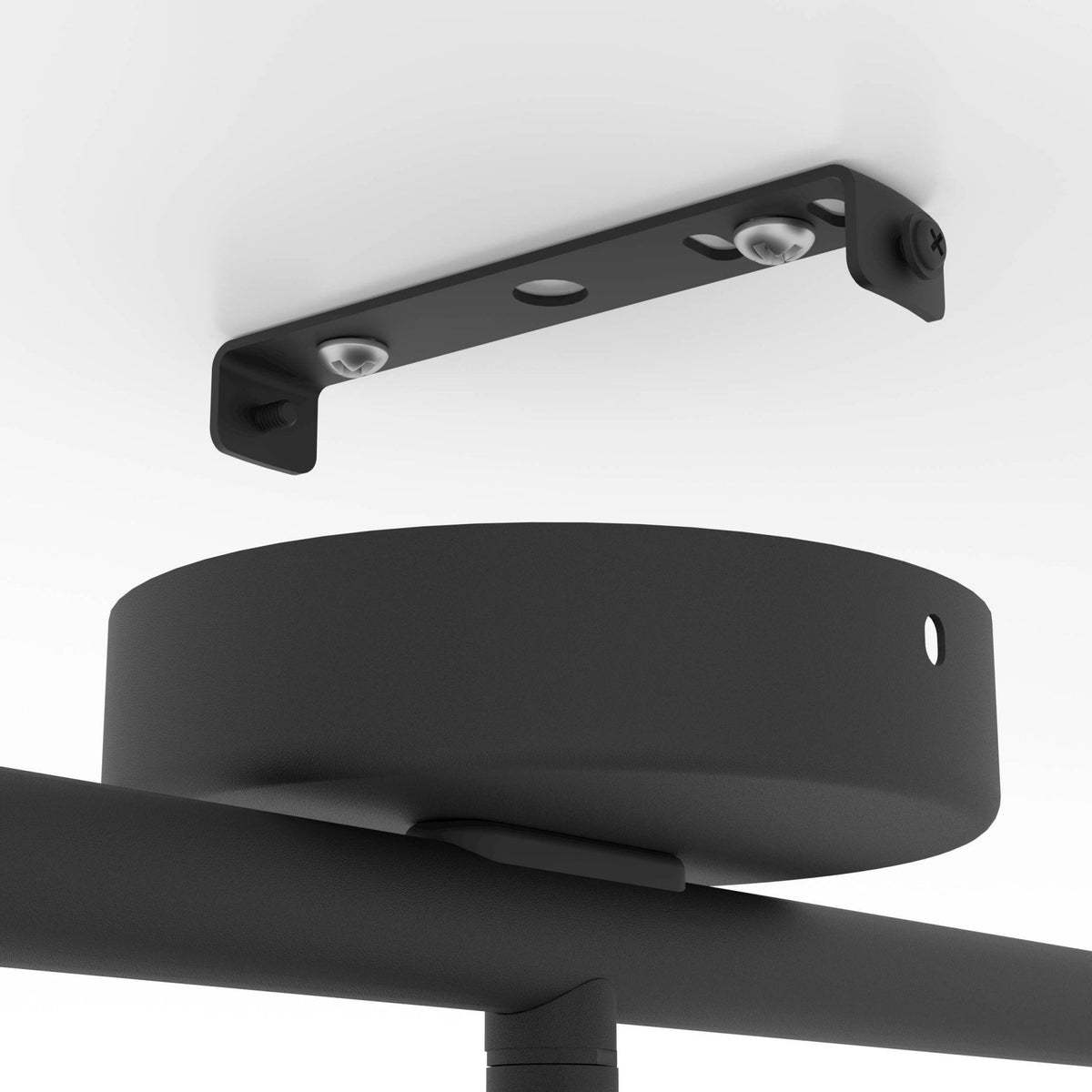 A close-up of the black ceiling mounting bracket for a track light against a white ceiling.