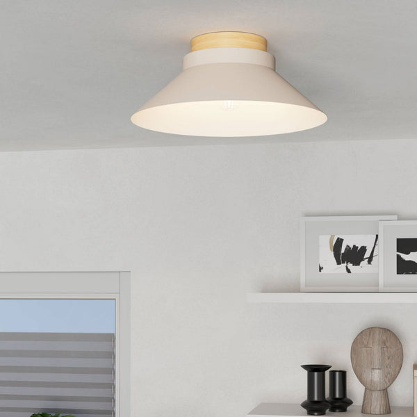 A beige flush mount light with a wooden top is installed on a white ceiling.