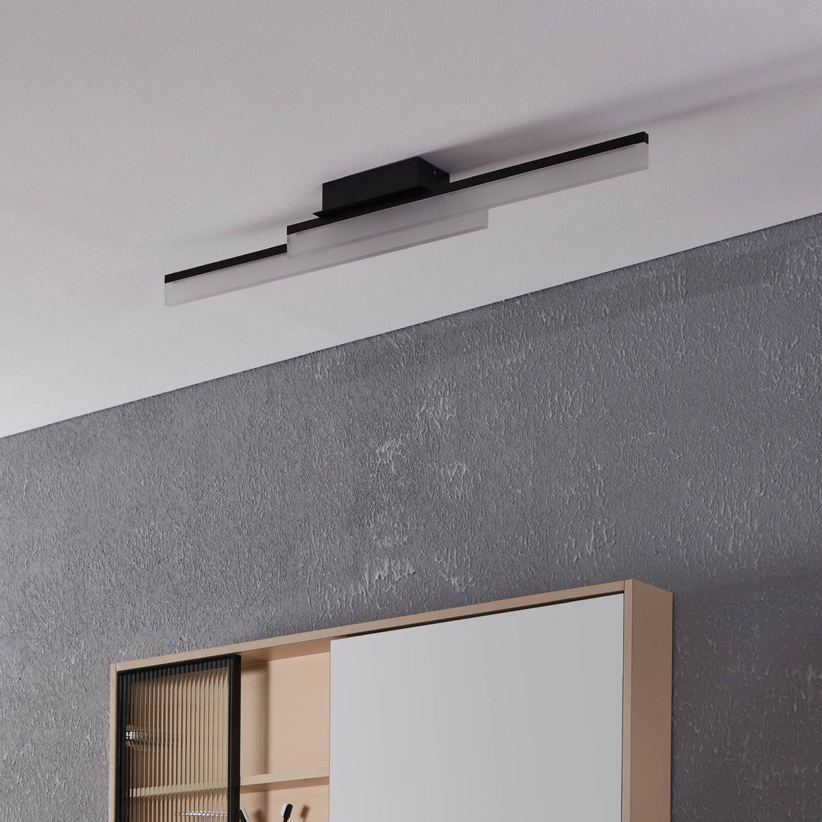 Linear LED ceiling light in black, with two rectangular bars of light, installed in a room.