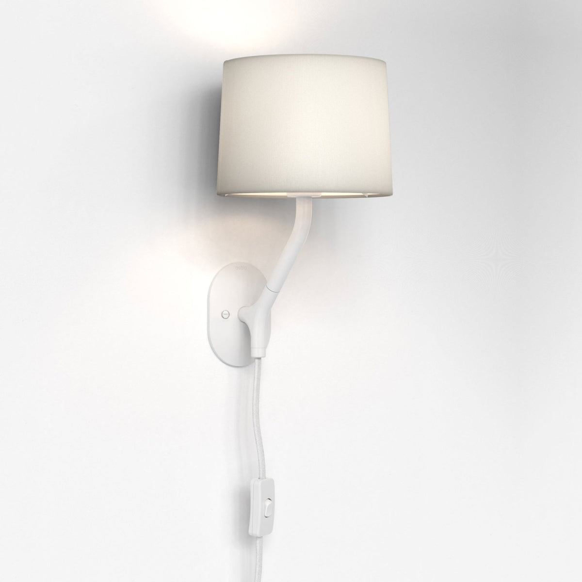 White wall light with a fabric shade and a curved arm, mounted on a white wall