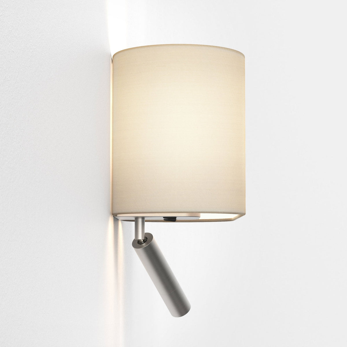 Wall-mounted lamp with a cylindrical beige fabric shade and an adjustable brushed metal spotlight below