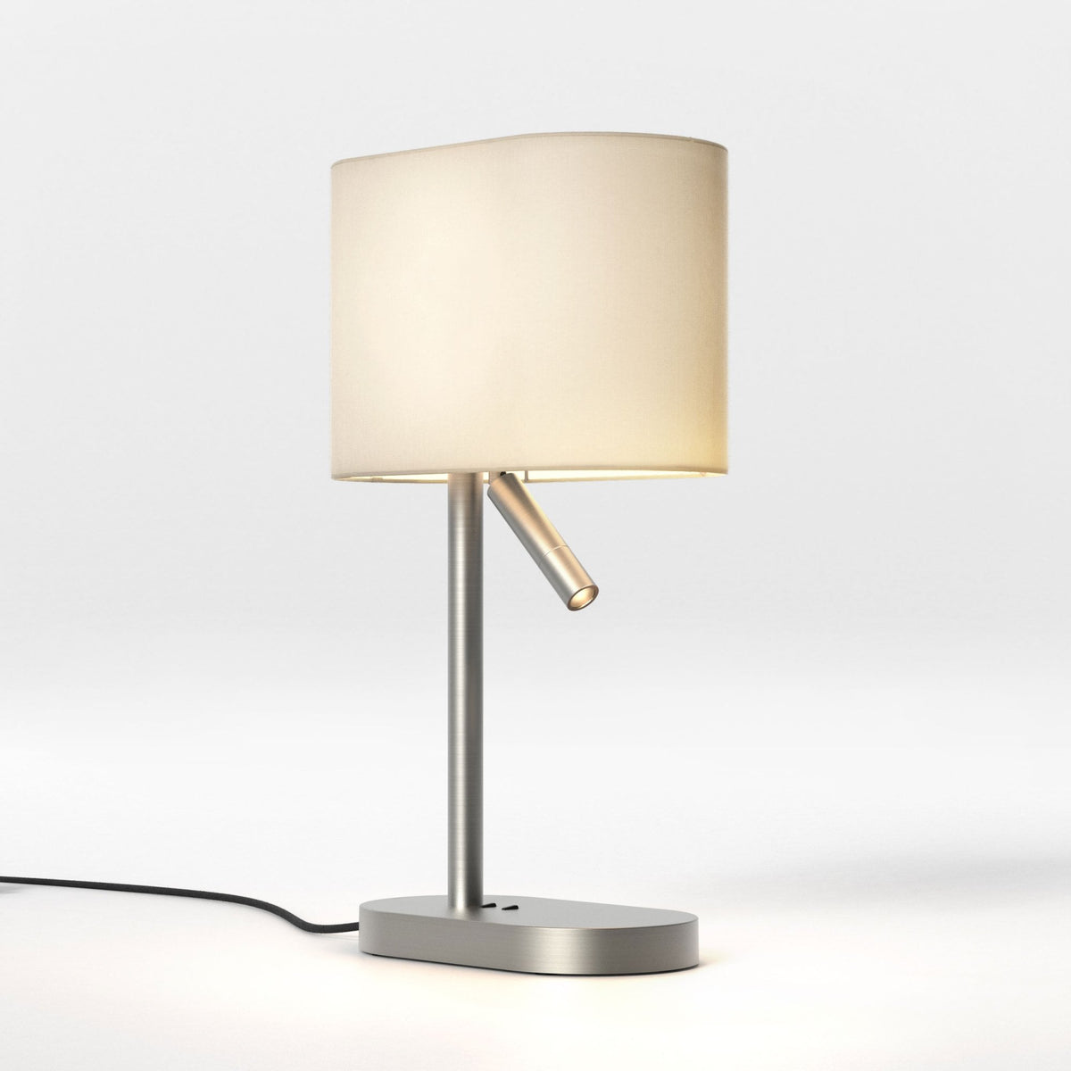 Brushed metal table lamp with an oval base, a cylindrical stem, a cream fabric shade, and an adjustable reading light