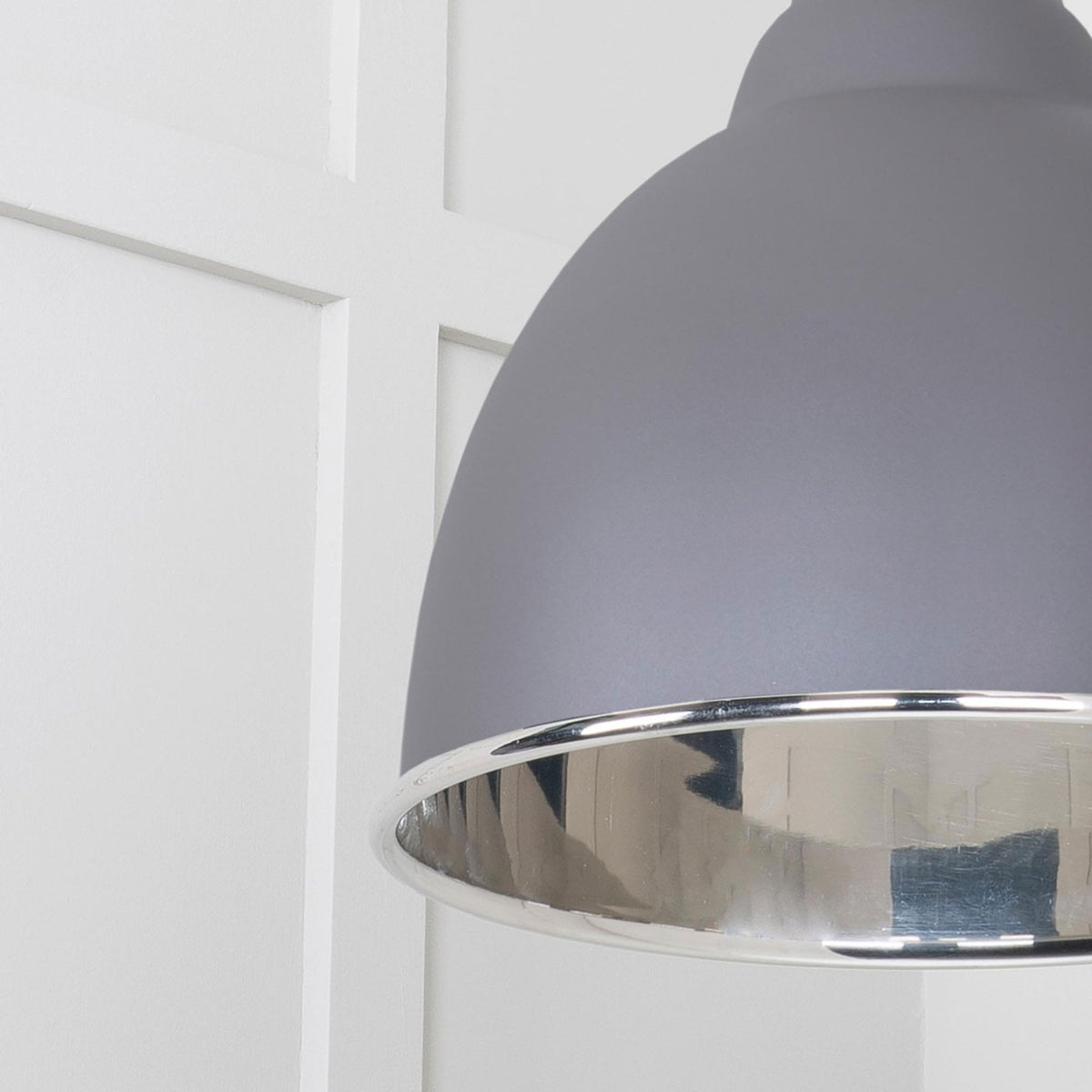 A close-up of the dark grey dome pendant light's silver interior and reflective surface.