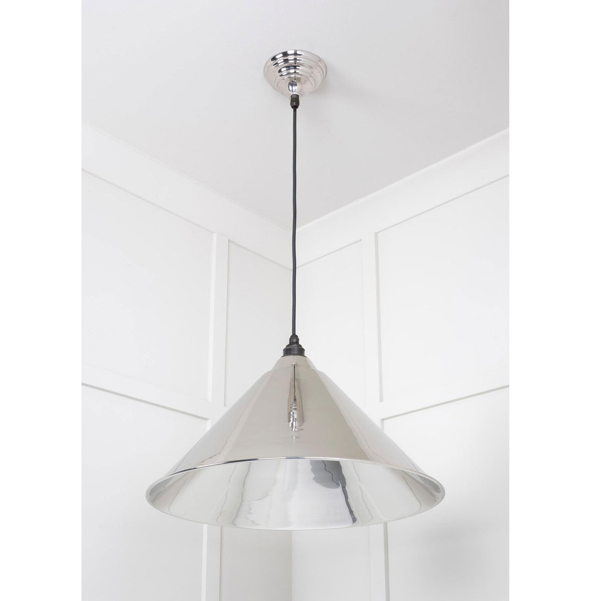 The contemporary polished chrome pendant light, adding a modern touch.