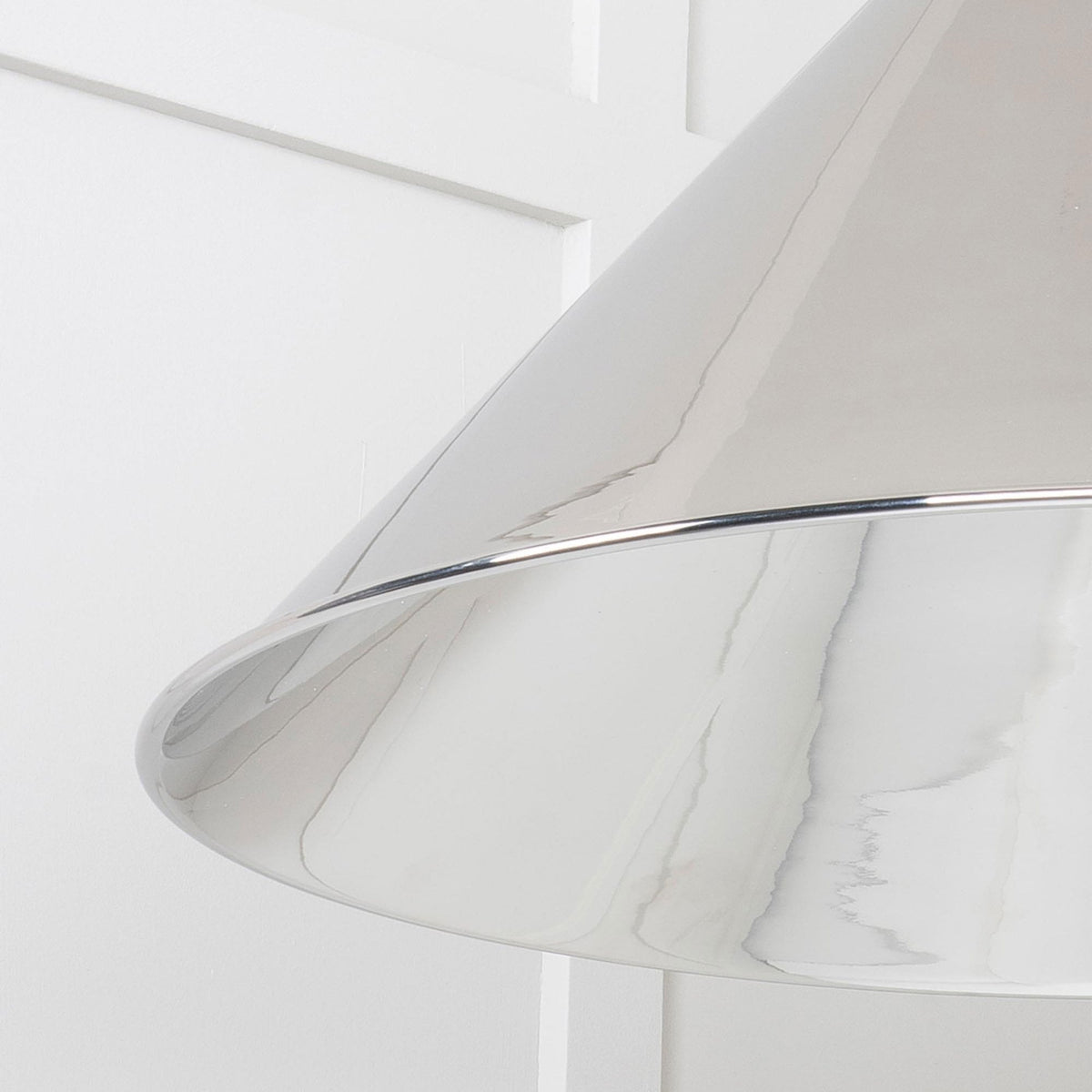 A close-up of the elegant polished chrome pendant light for a sleek look.