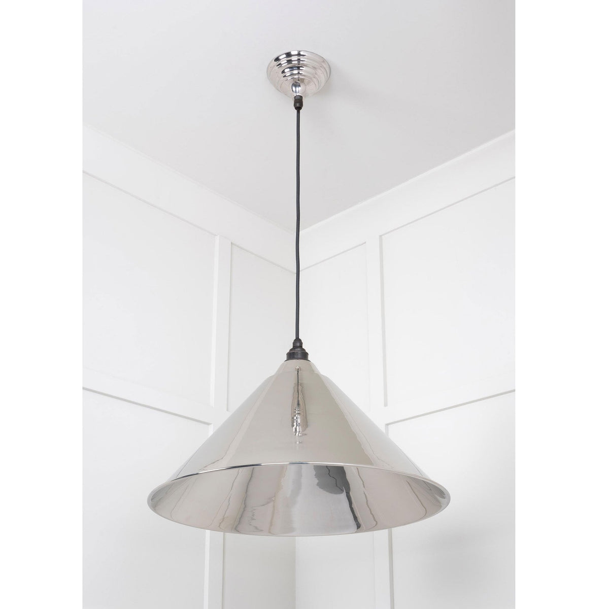 A striking polished chrome pendant light, a focal point in any interior.