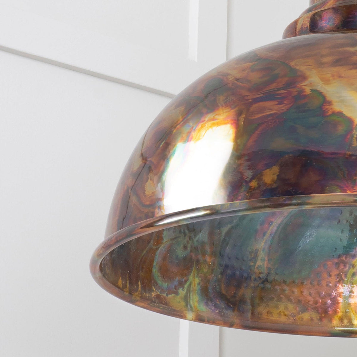 Detailed close-up of the dome pendant light’s metallic iridescent surface and rim.