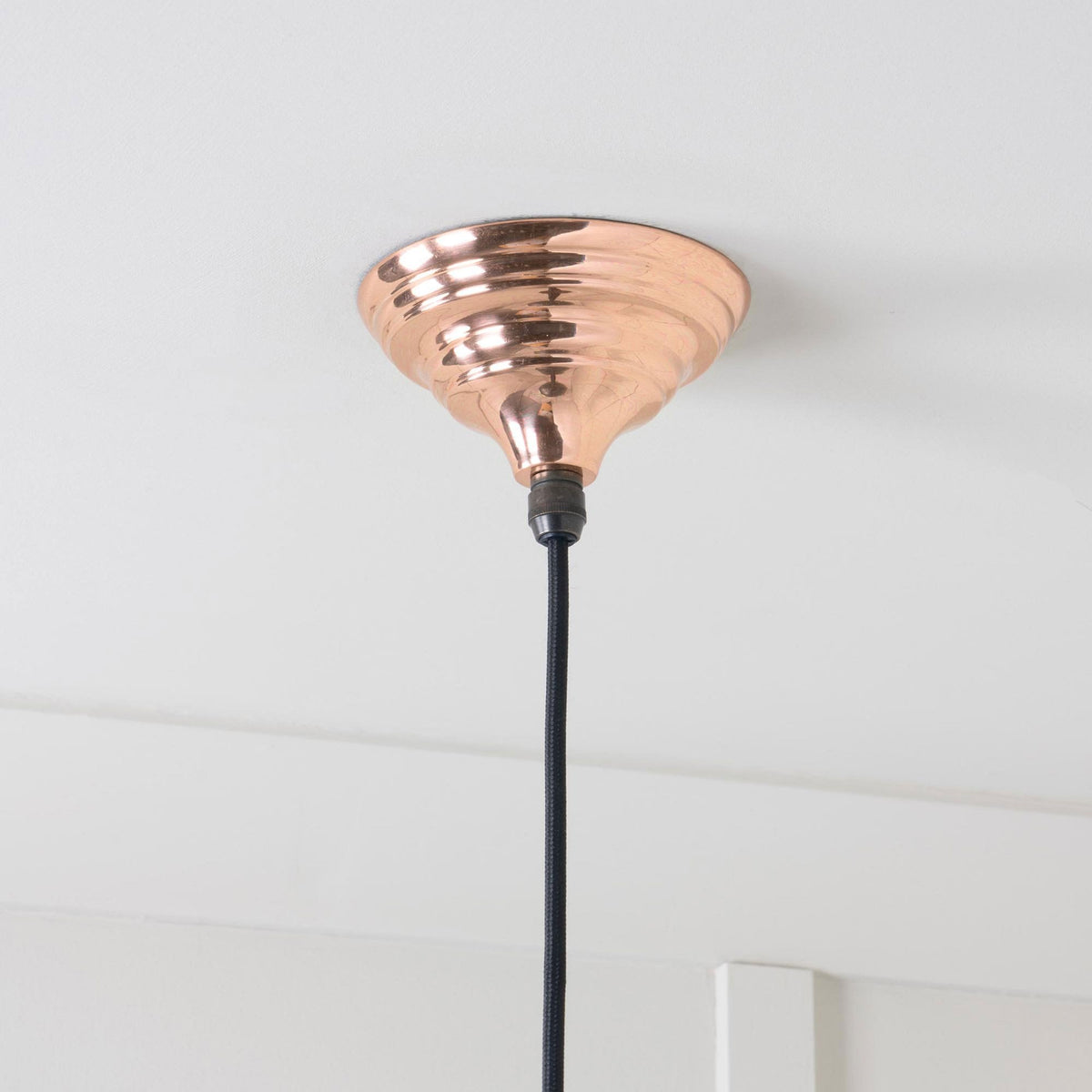 A close-up of the ceiling rose for the copper pendant light.