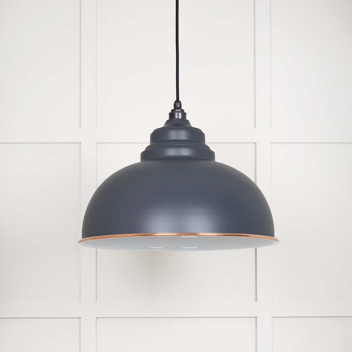 The Oxford pendant light against a white panelled wall.