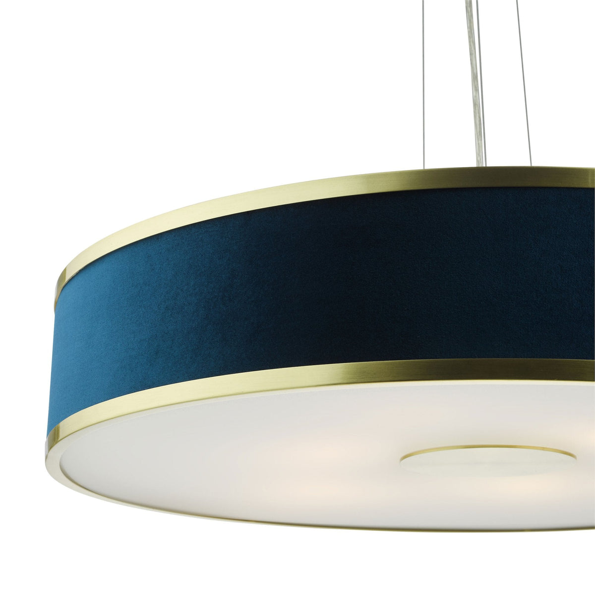 Close-up of a round, blue fabric pendant light with gold trim and a white diffuser.