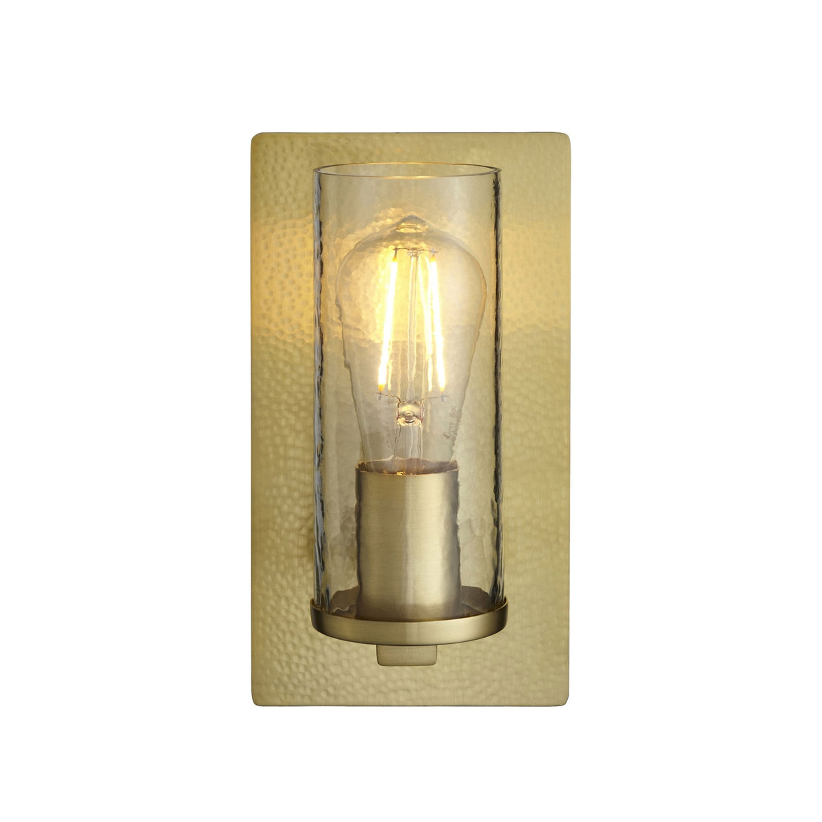 A rectangular, hammered gold wall sconce with a clear glass cylinder and exposed bulb on a white background.