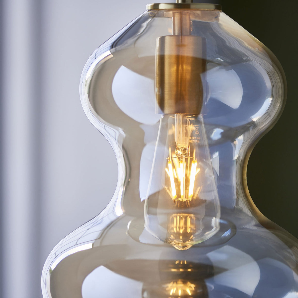 Kelda Shaped Single Pendant with Champagne Lustre Glass and Satin Brass Detailing