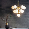 Oscar Eleven Light Pendant in Brushed Brass with White Glass Shades
