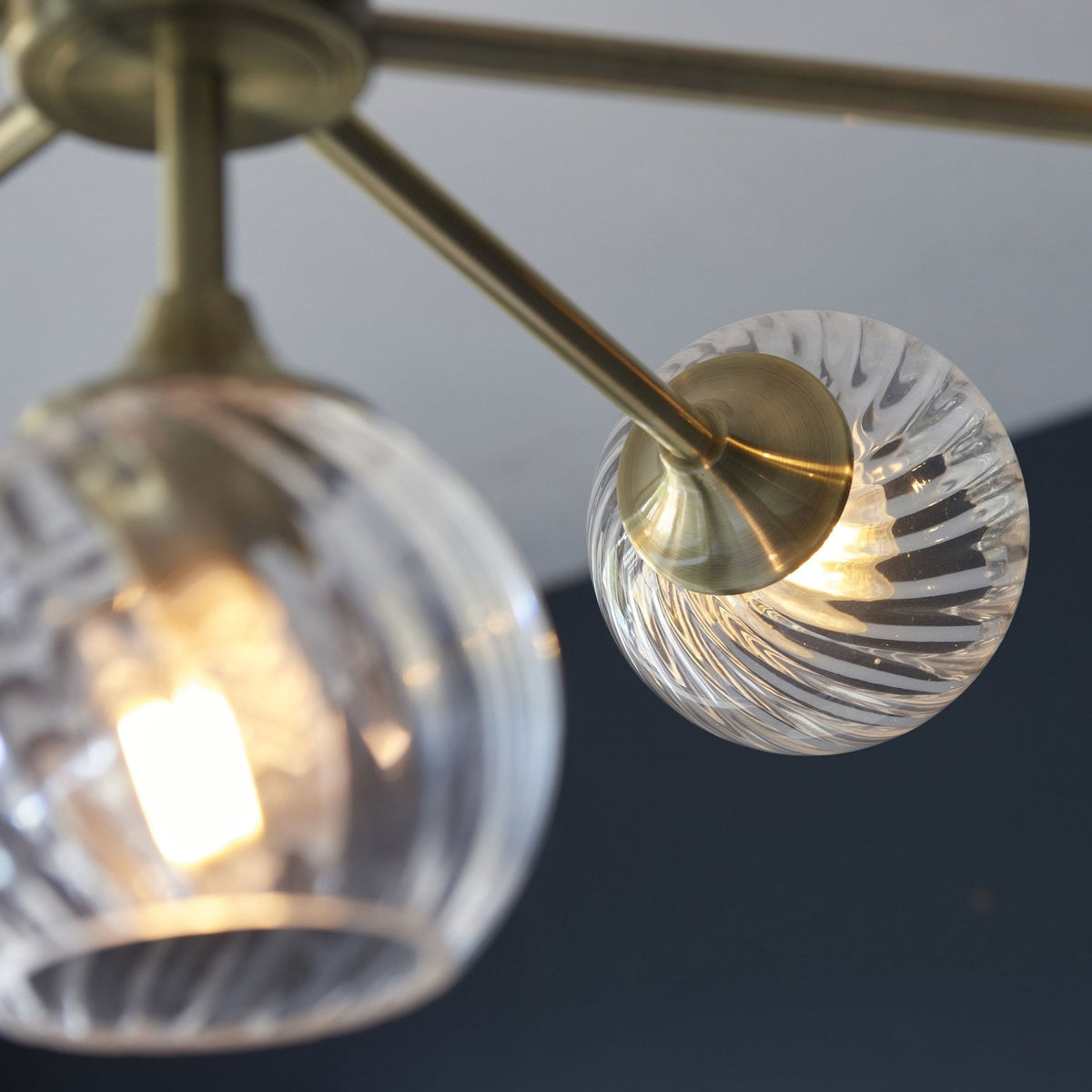Allegra Eight Light Adjustable Height Semi Flush in Antique Brass with Twisted Glass Shades
