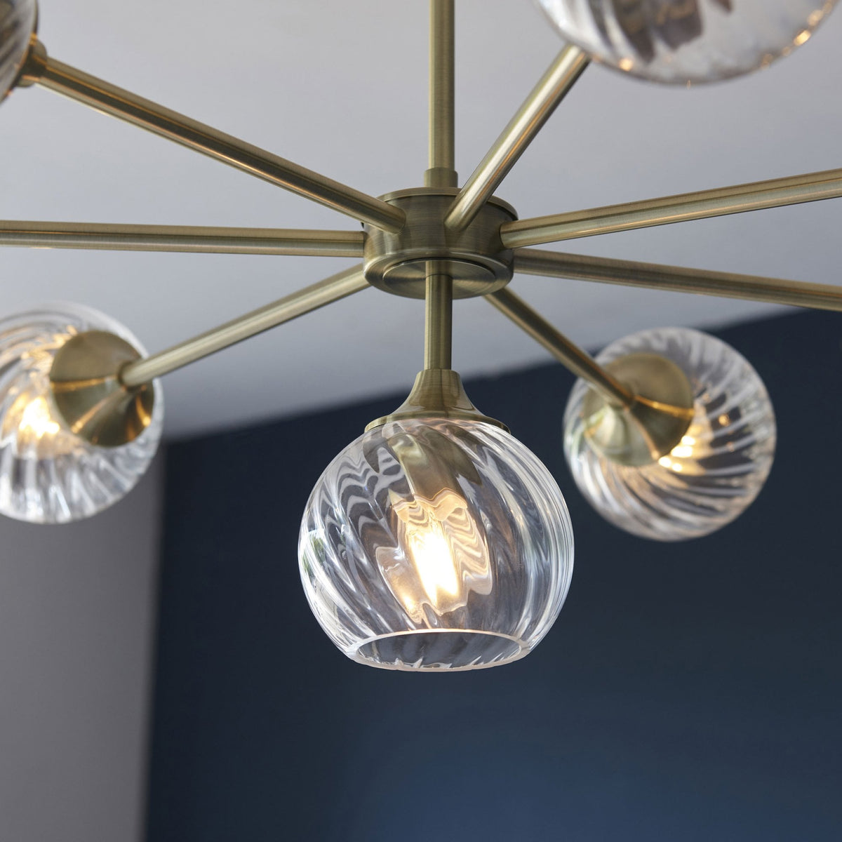 Allegra Eight Light Adjustable Height Semi Flush in Antique Brass with Twisted Glass Shades