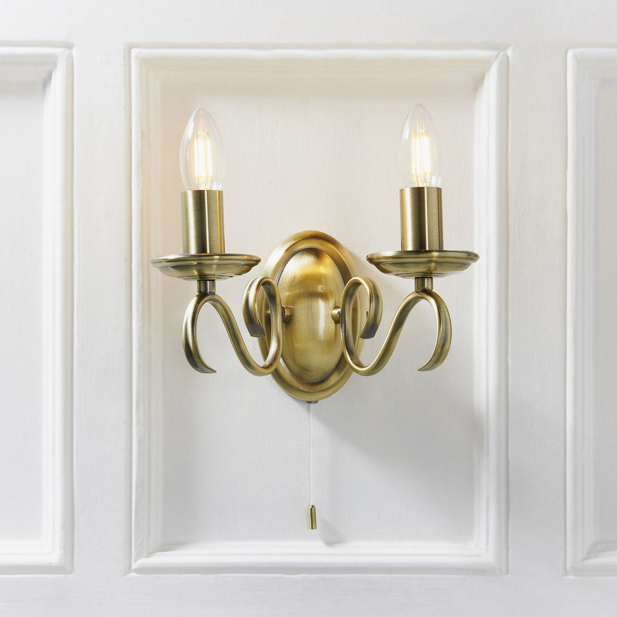 Bernice Two Arm Switched Wall Light in Antique Brass