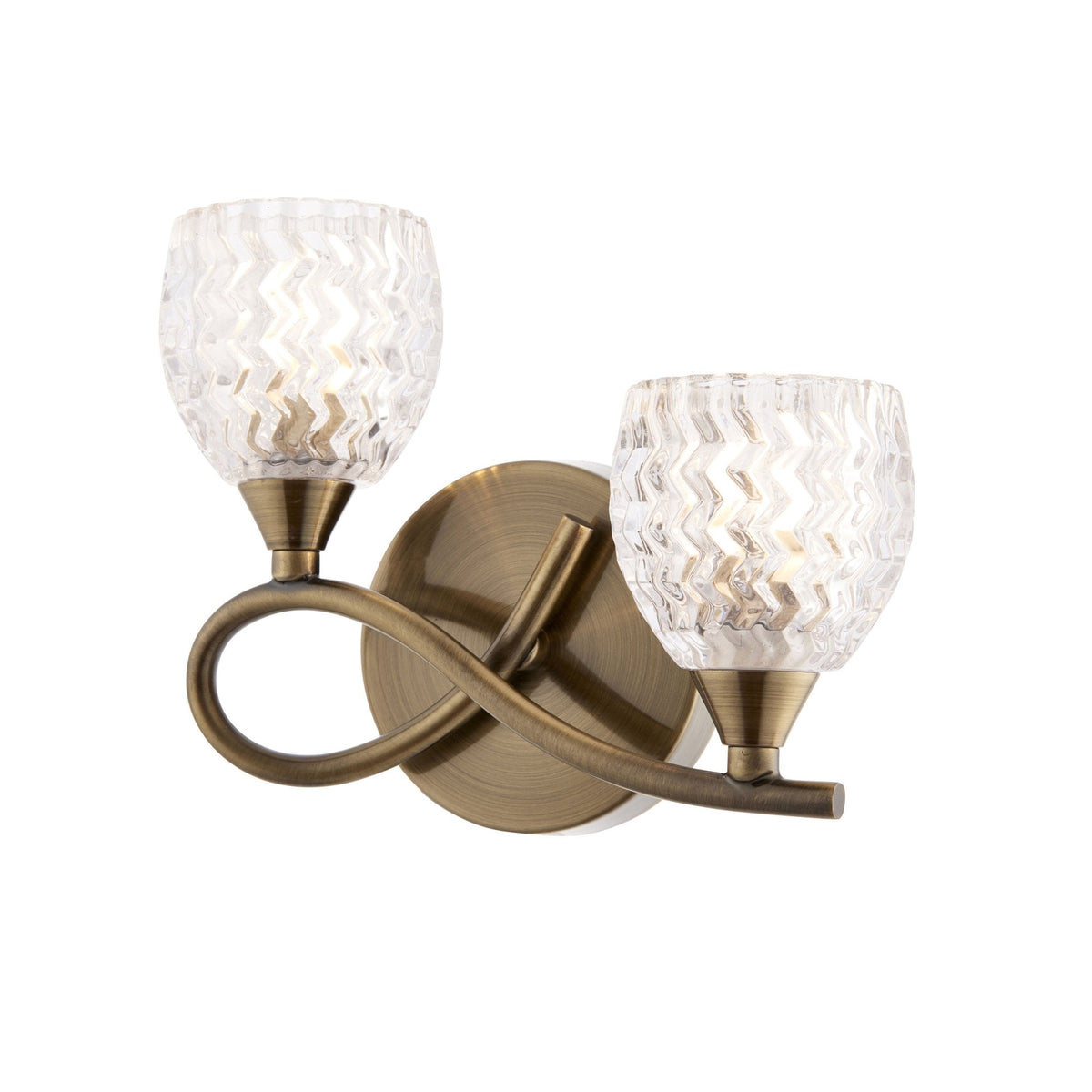 Two-light wall sconce with clear, textured glass shades and an antique brass finish on a white background.