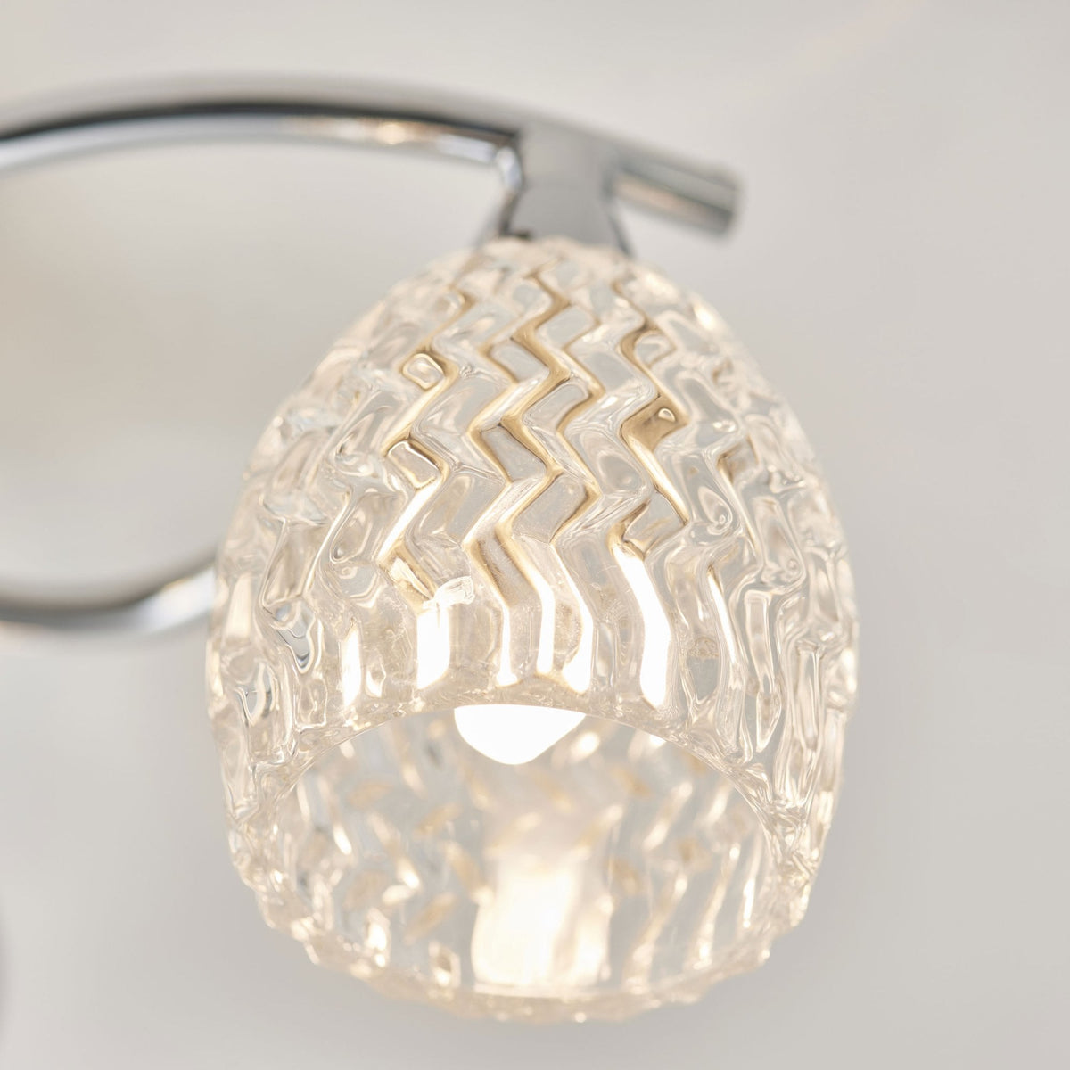 Close-up of a single textured glass shade with a zigzag pattern.