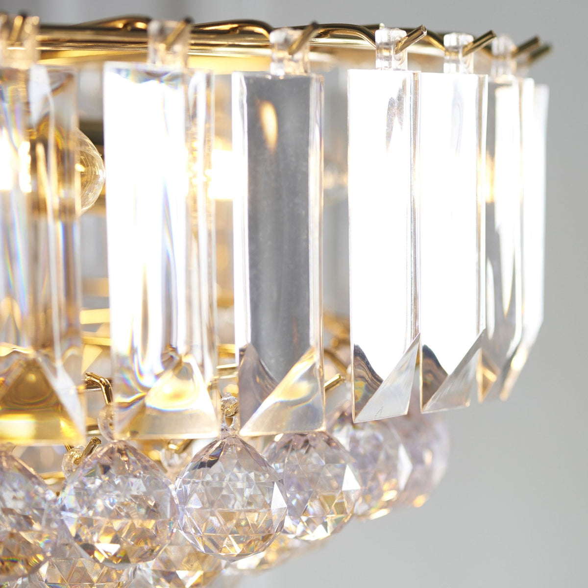 Close-up of the crystal prisms and hanging beads of a chandelier.
