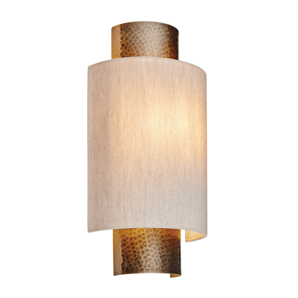 Cylindrical wall light with a textured brass base and top, and a light fabric shade, illuminated on a white background.
