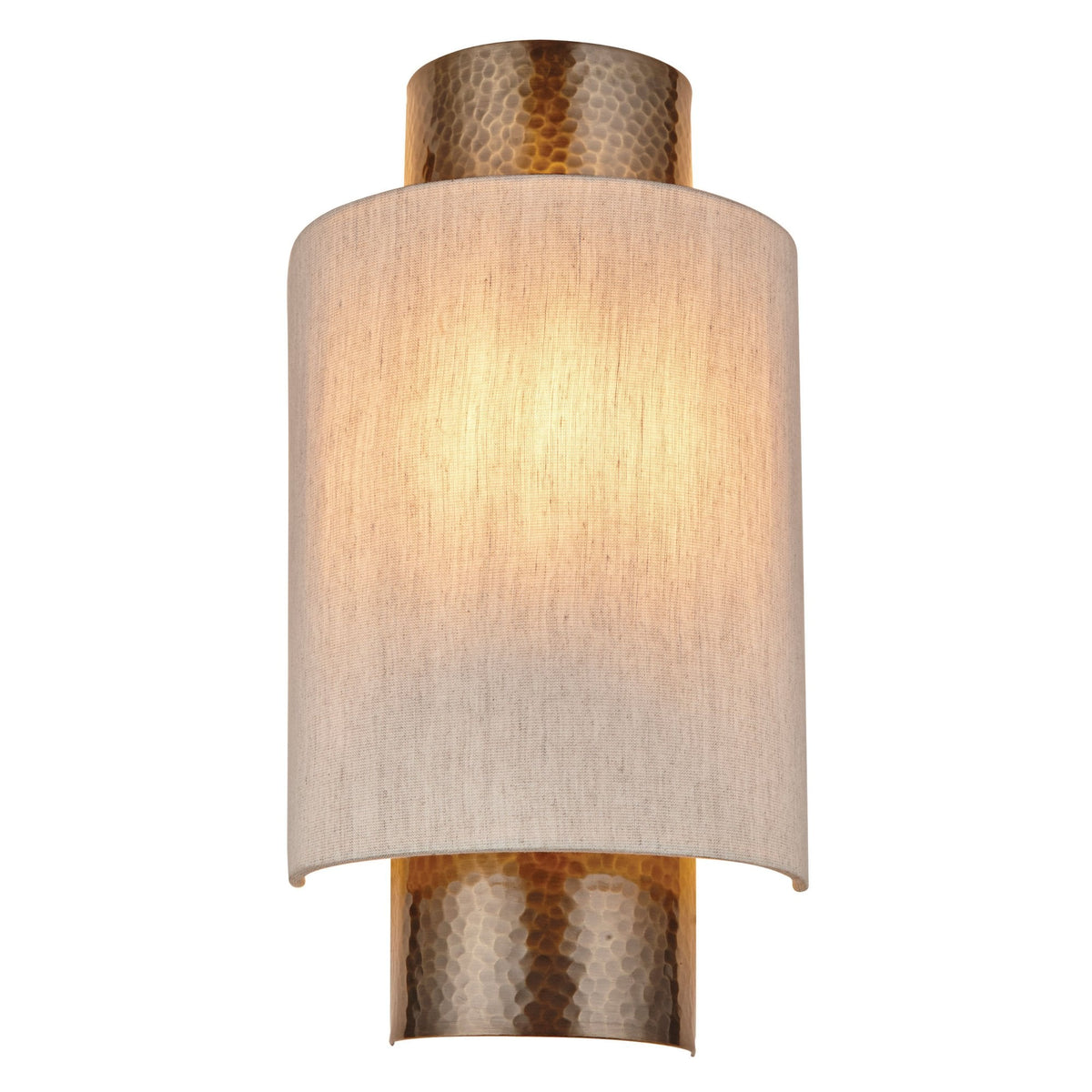 Front view of an illuminated cylindrical wall light with a textured brass base and top, and a light fabric shade.