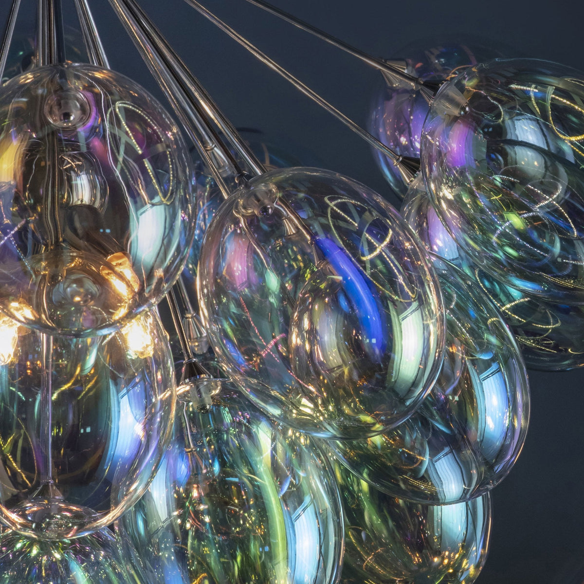 Detailed view of the iridescent glass shades on a chandelier, showing colorful reflections.