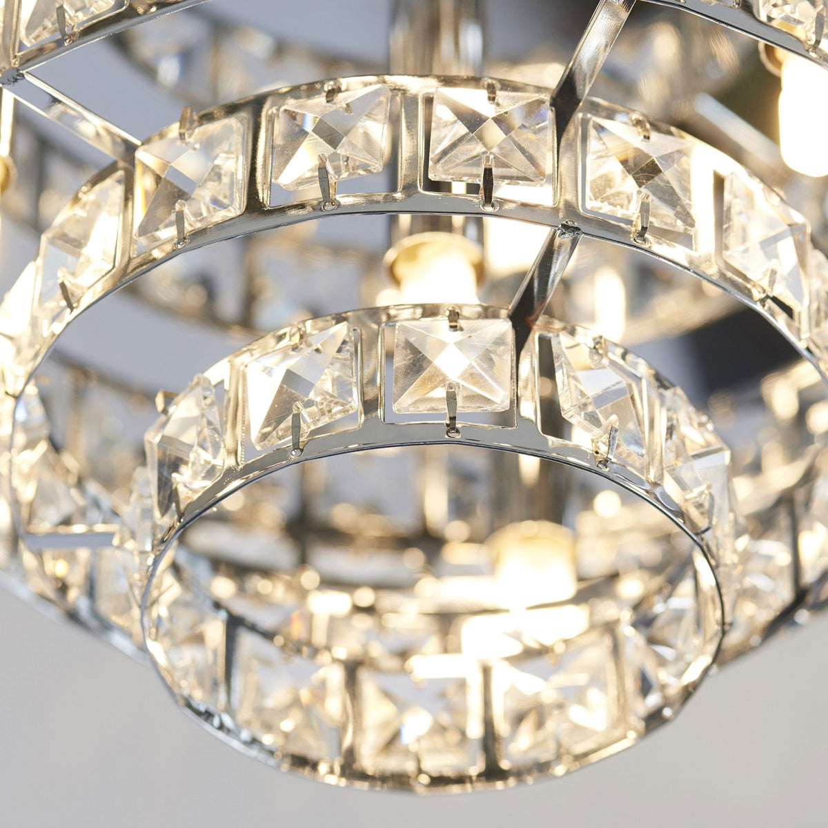 Close-up of the tiered crystal flush ceiling light, showing individual square crystals and internal bulbs.