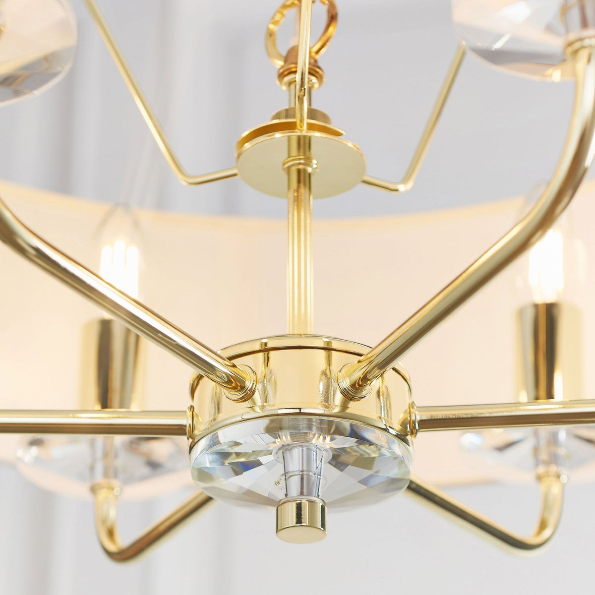 Close-up of the chandelier's central gold column and crystal finial.