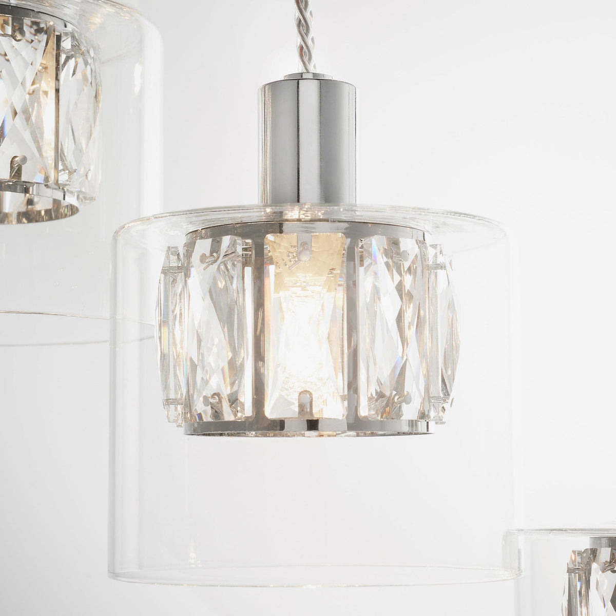 A single chandelier light with a clear glass shade, polished chrome top, and faceted crystal interior.