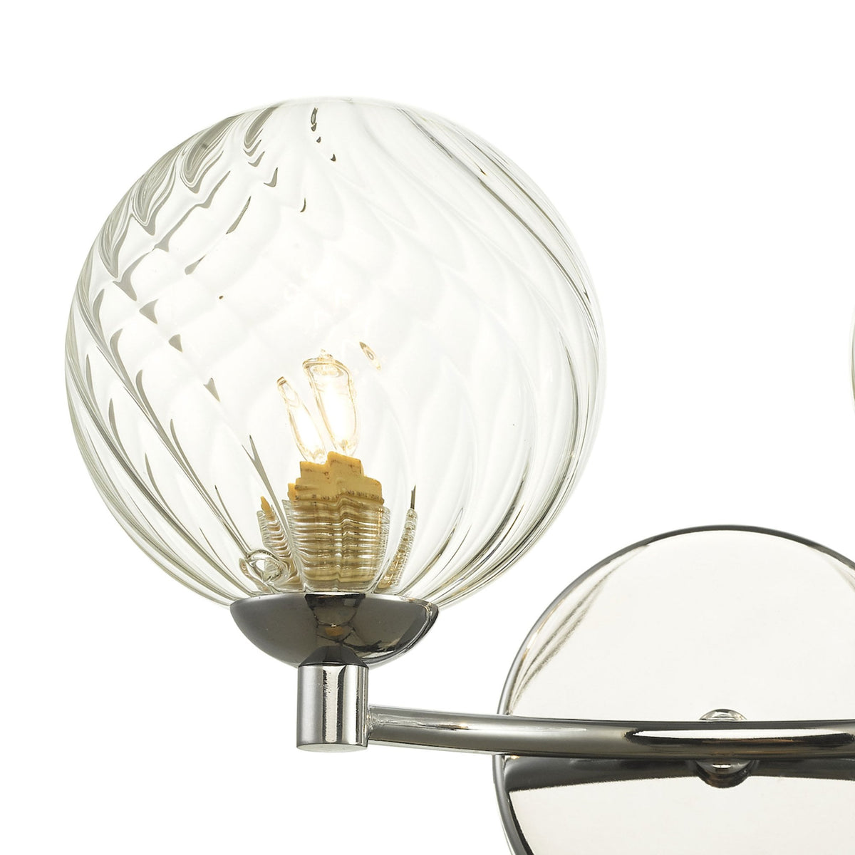 Close-up of a clear, textured glass globe light fixture with a visible bulb and chrome base.