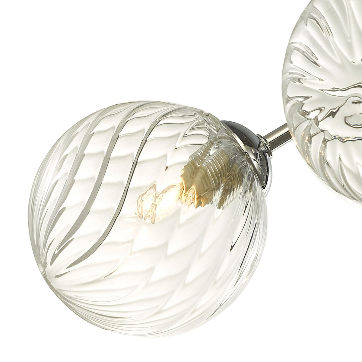 Close-up of a clear, textured glass light fixture with a glowing bulb inside.