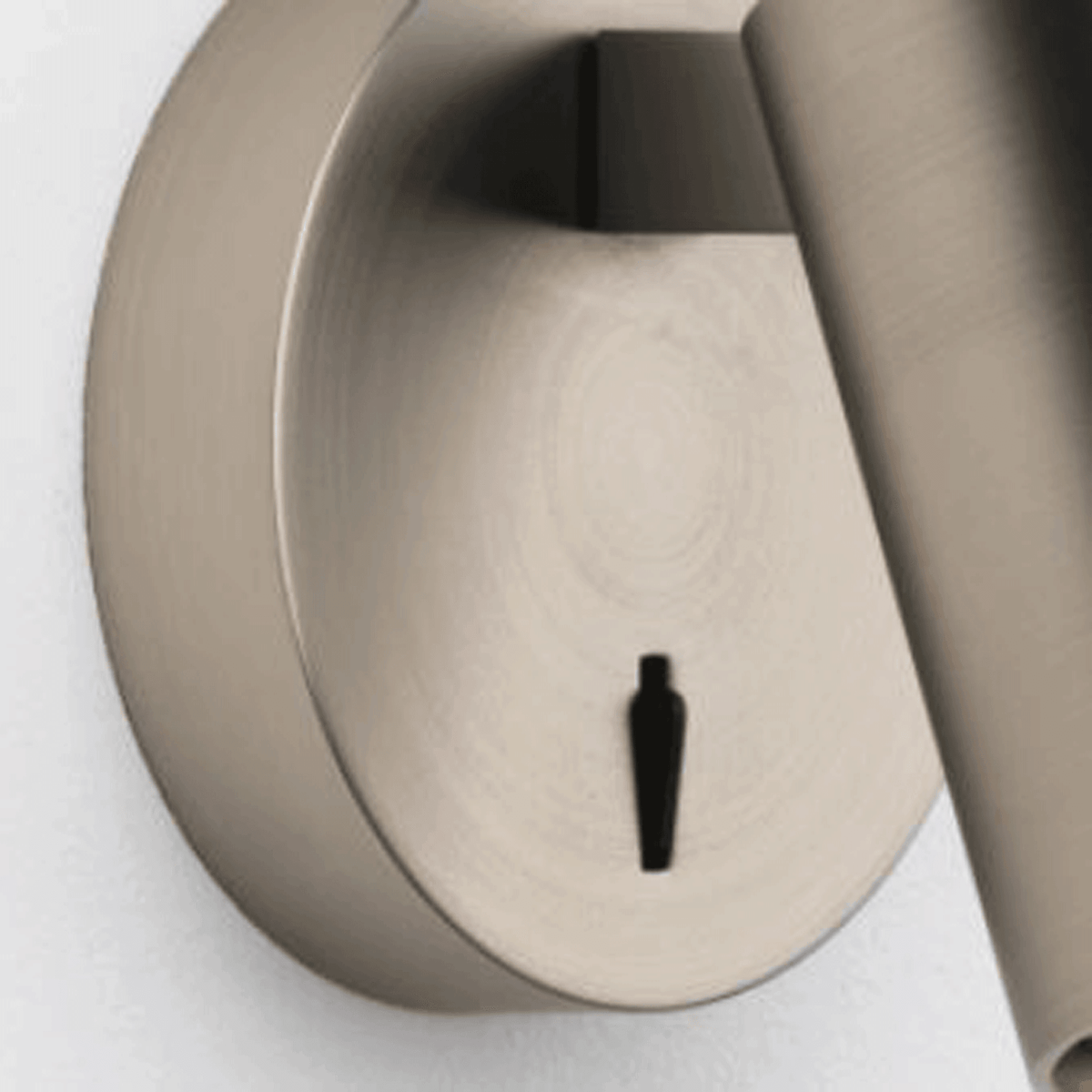A close-up of the base of a brushed steel wall light, showing the on/off switch.