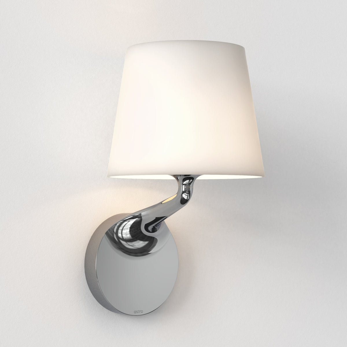Polished chrome wall light with a white fabric shade