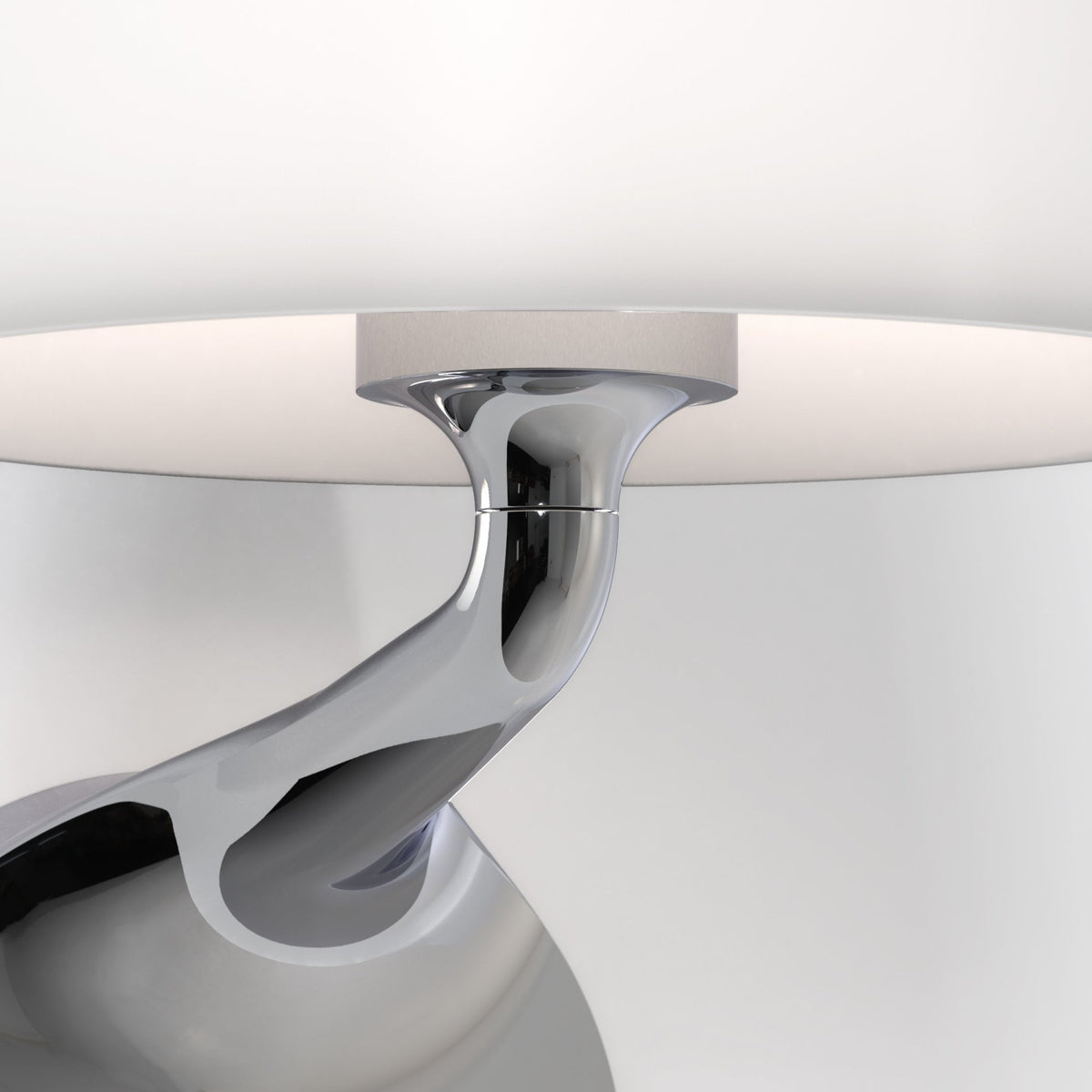 Close-up of a chrome lamp base with a white lampshade