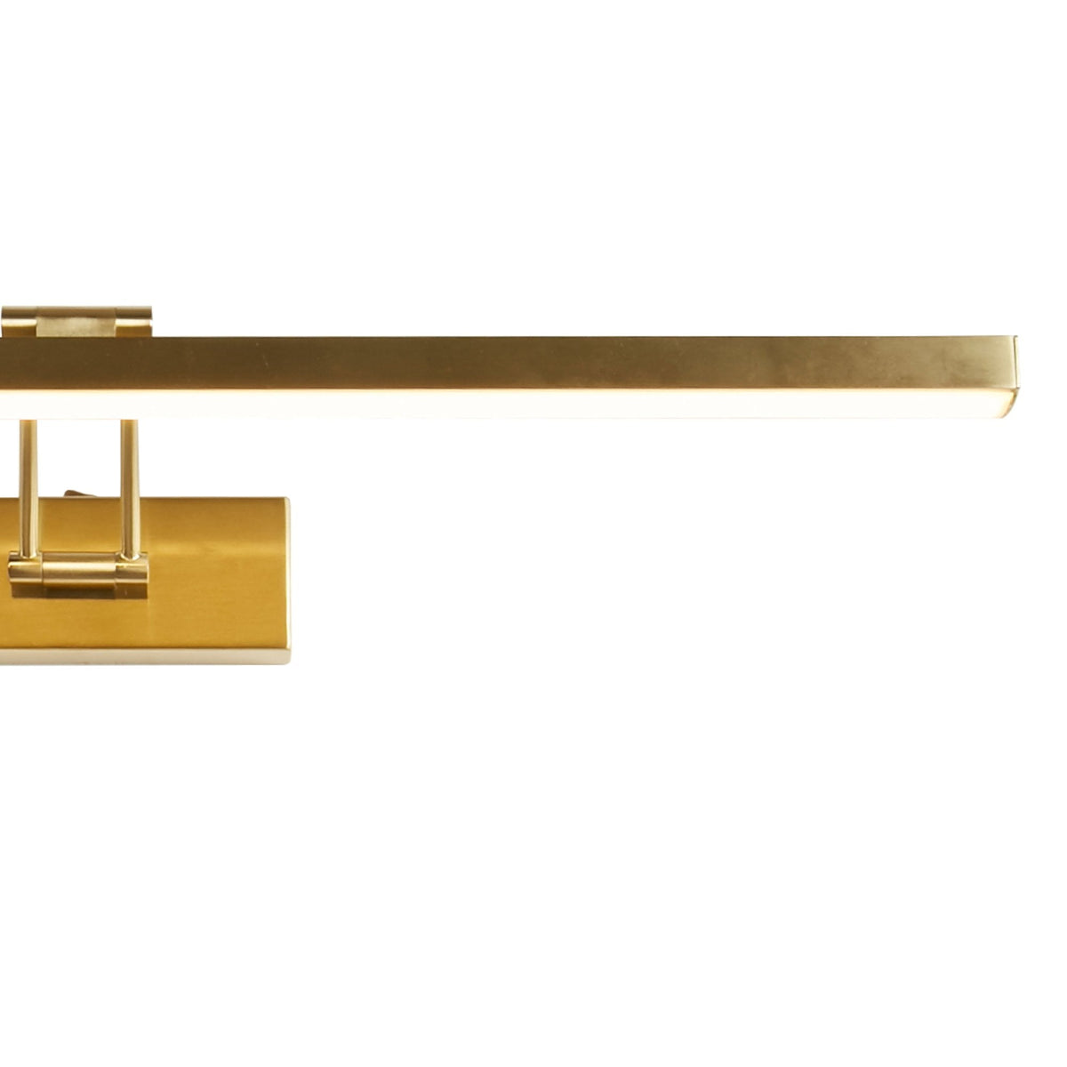 Close-up of a gold picture light, highlighting its design and illumination.