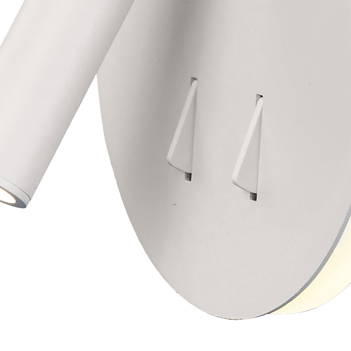 Close-up of the two push-button switches on the white wall light's circular base.